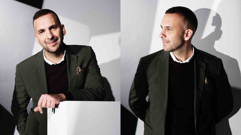 Zack Polanski wears a black jumper over a white shirt beneath a green blazer, leaning over a white podium; on the right, he is pictured looking to the left
