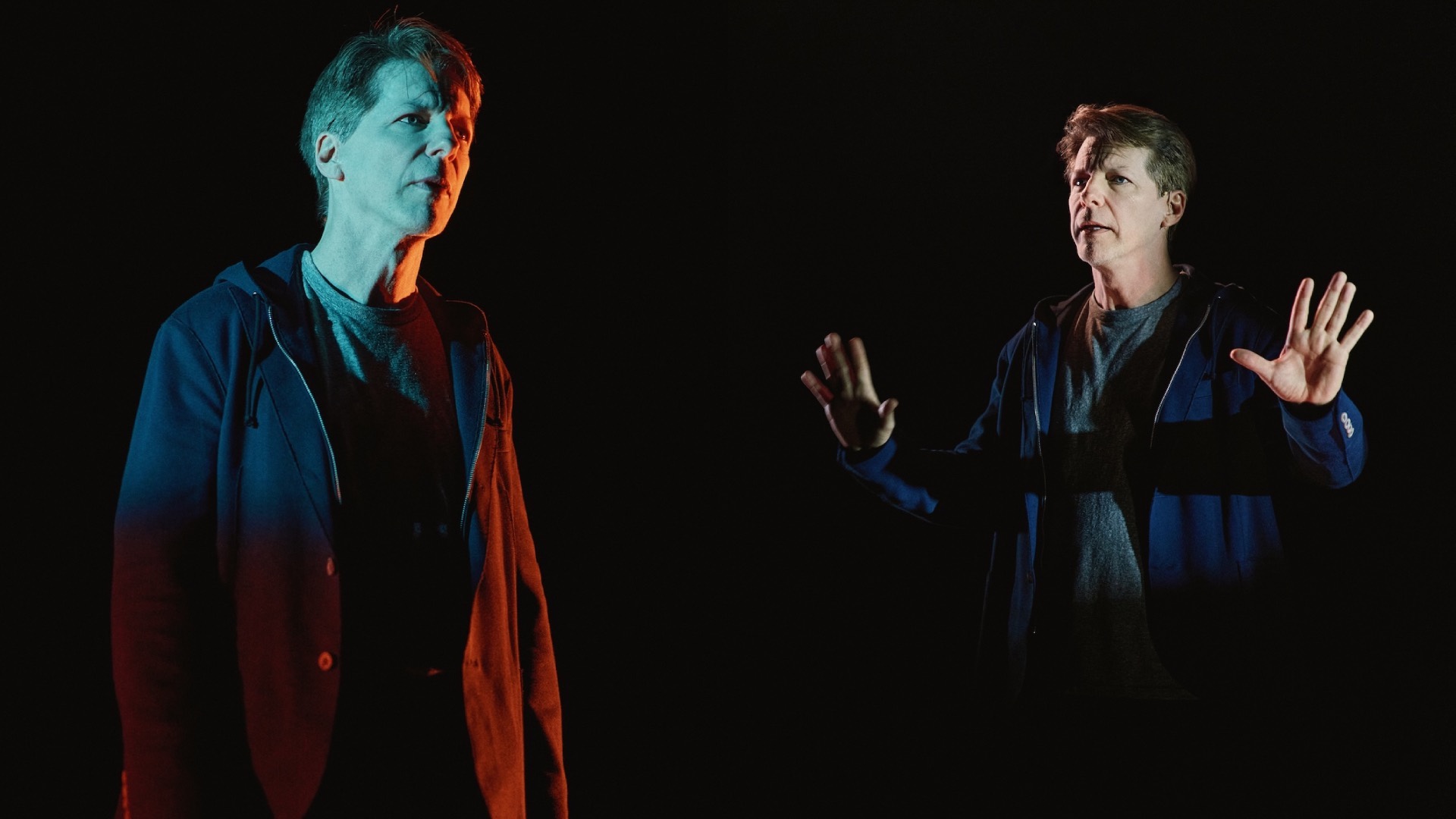 Sean Hayes in The Unknown dimly lit by an overhead light