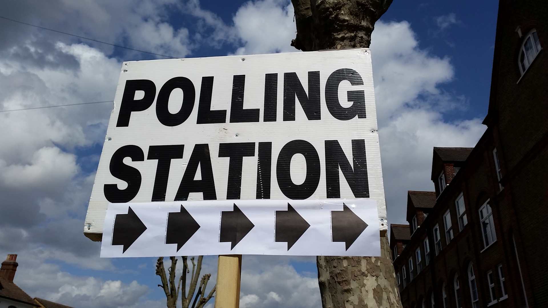 A sign saying "Polling Station" with arrows underneath it
