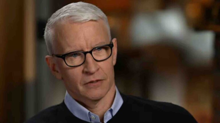 Anderson Cooper in a blue collard shirt