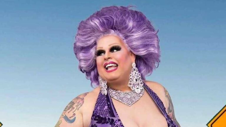 Maxi Shield RuPaul’s Drag Race Down Under headshot, wearing a purple wig and matching dress