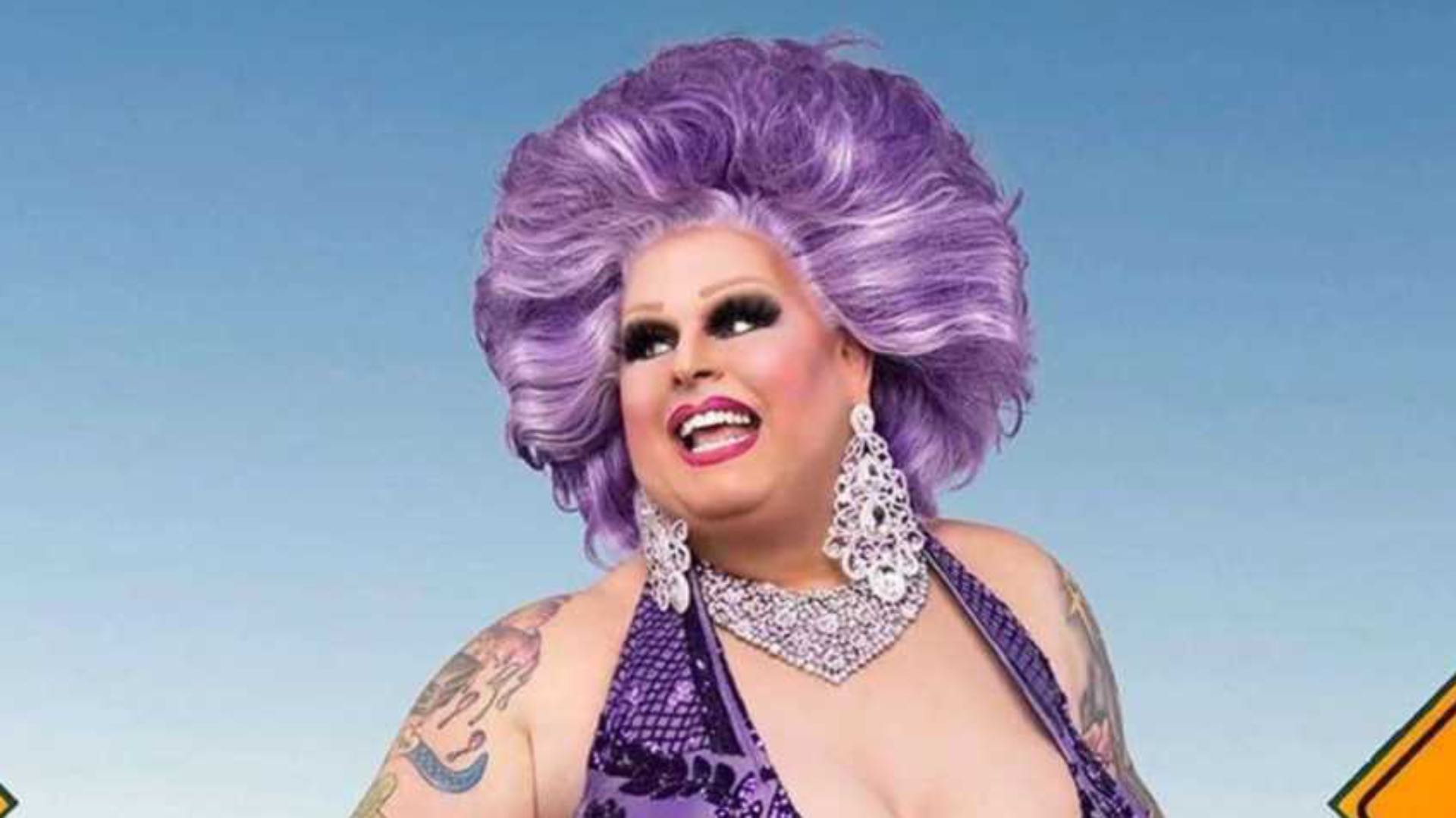 Maxi Shield RuPaul’s Drag Race Down Under headshot, wearing a purple wig and matching dress
