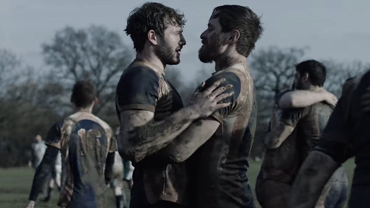 In From the Side, which explored themes of masculinity in gay spaces - pictured are the films to leads embracing each other on a rugby pitch
