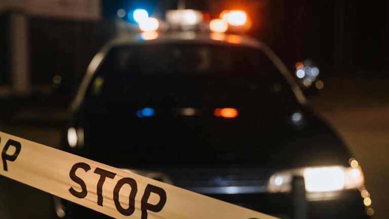 Police car behind yellow tape