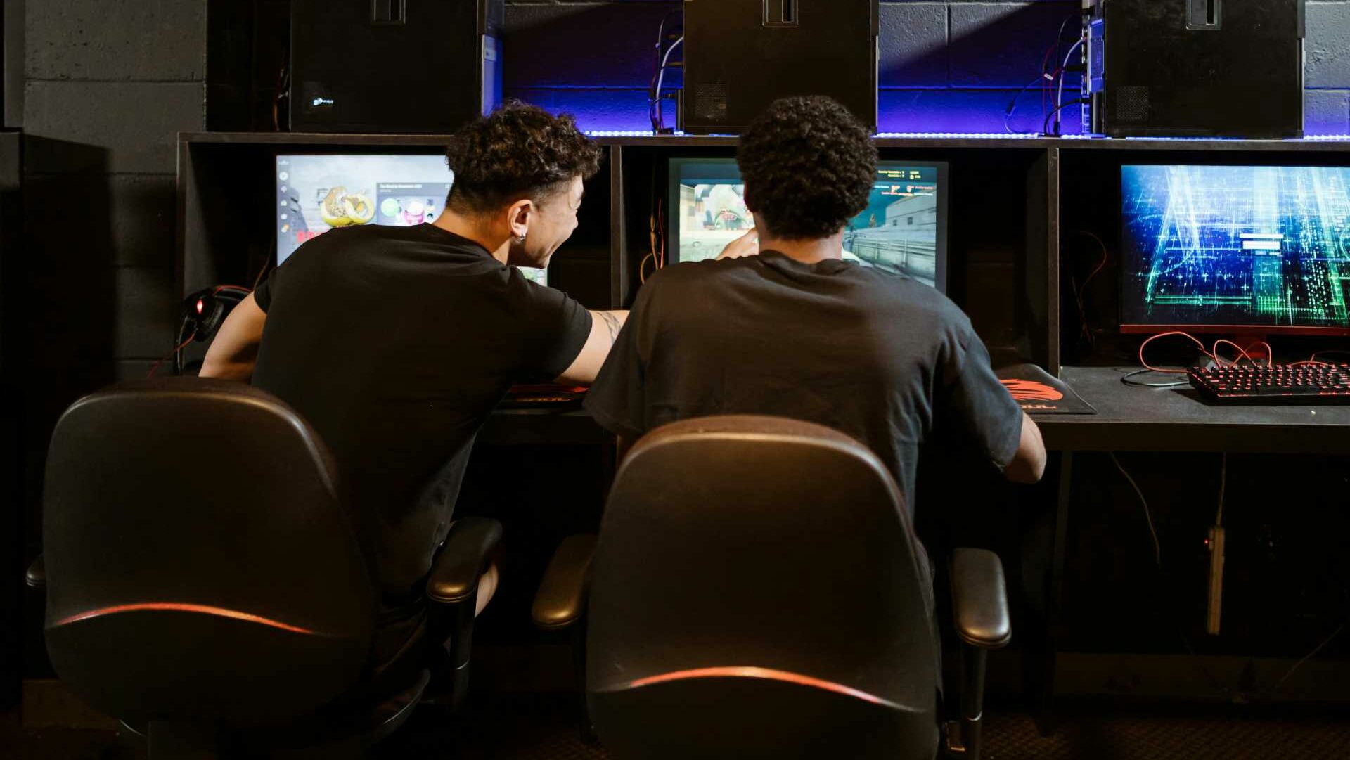 Two men gaming on PCs