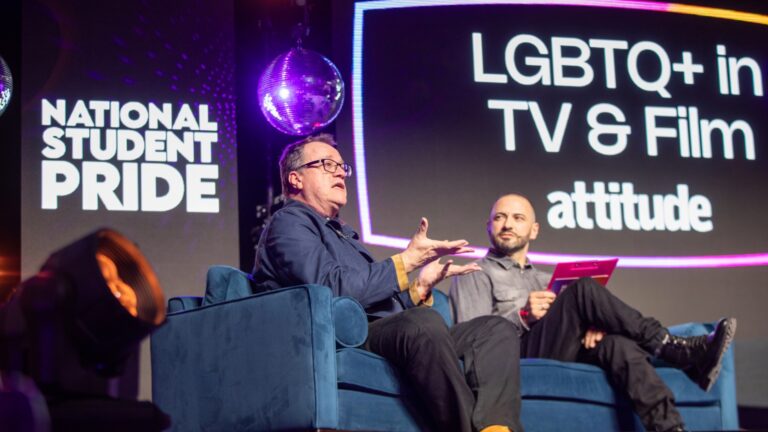 Russell T Davies and Cliff Joannou are pictured on-stage at a National Student Pride event