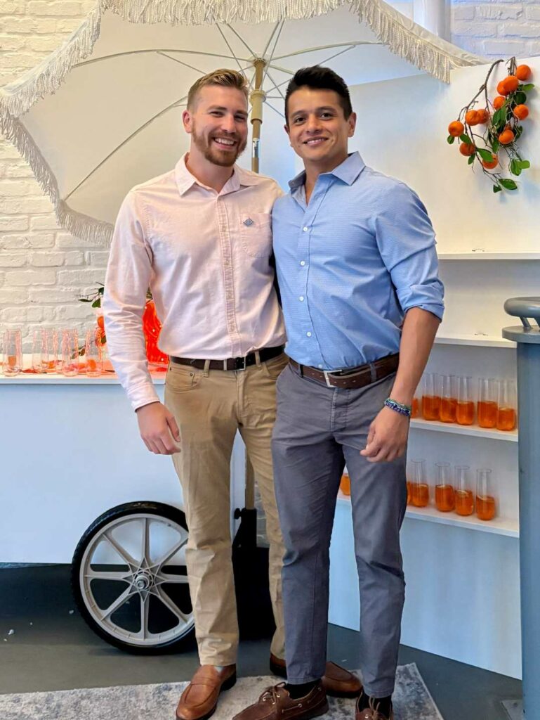 Two smiling men in shirts holding each other