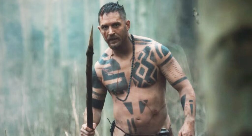 Tom Hardy tattooed naked in Taboo holding a spear with blood dripping down his face