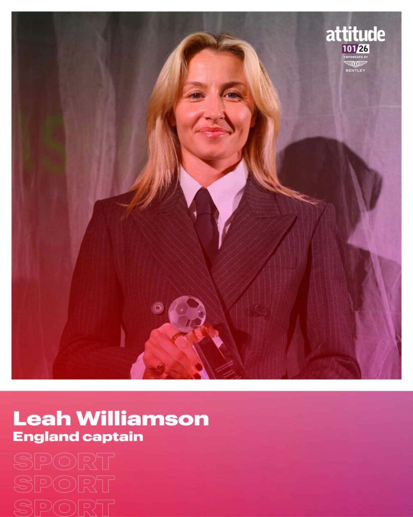 A portrait of Leah Williamson holding a glass football trophy, wearing a dark pinstripe blazer with a white shirt and dark tie, with long blonde hair, against a softly lit purple and grey background. The image is overlaid with Attitude 101 2026 branding and text identifying her as England captain in the Sport category, empowered by Bentley.