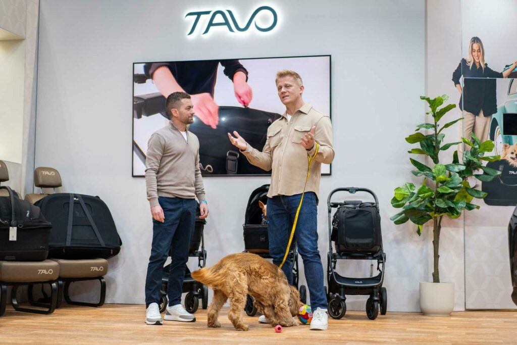 Adem Fehmi and Dr Scott Miller at Crufts at the TAVO stand with TAVO products and a dog