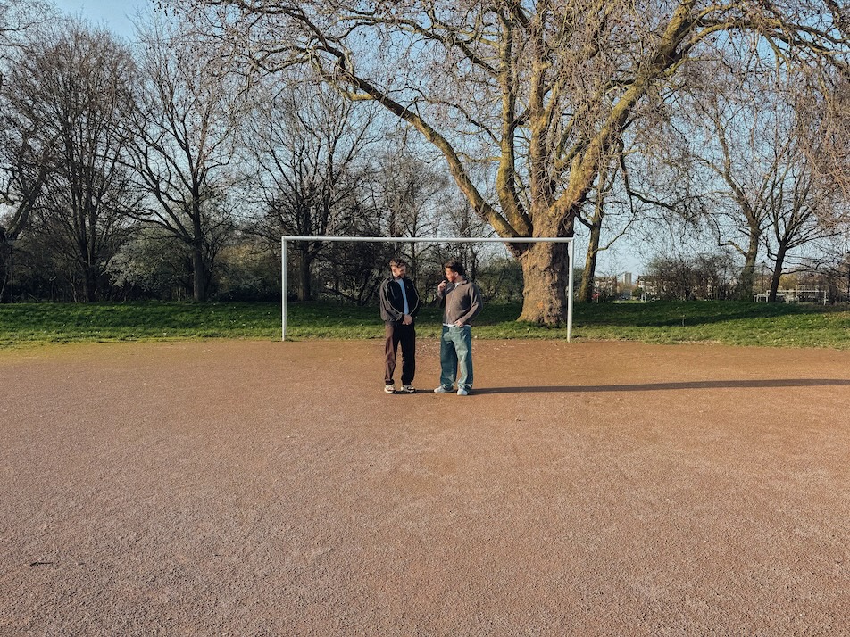 John Reavey and Joe Revens on a football pitch
