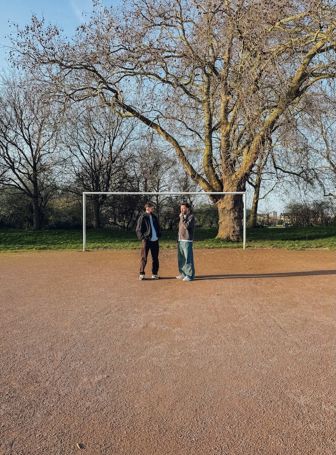 John Reavey and Joe Revens on a football pitch