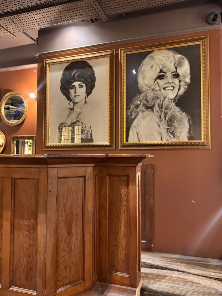 DJ booth at the Black Cap showing portraits of drag queens