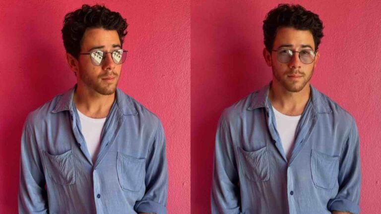 Nick Jonas in a denim jacket and glasses