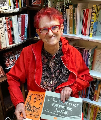 Nettie Pollard with red hair holding a book
