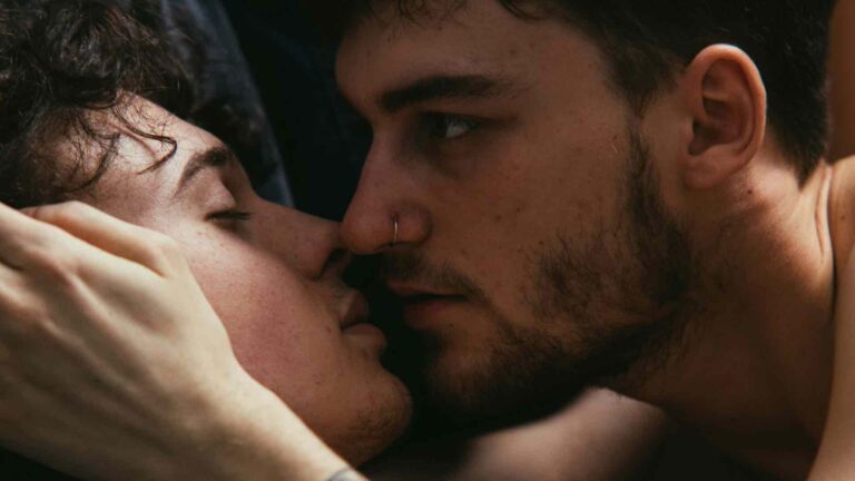 two men holding each other's faces