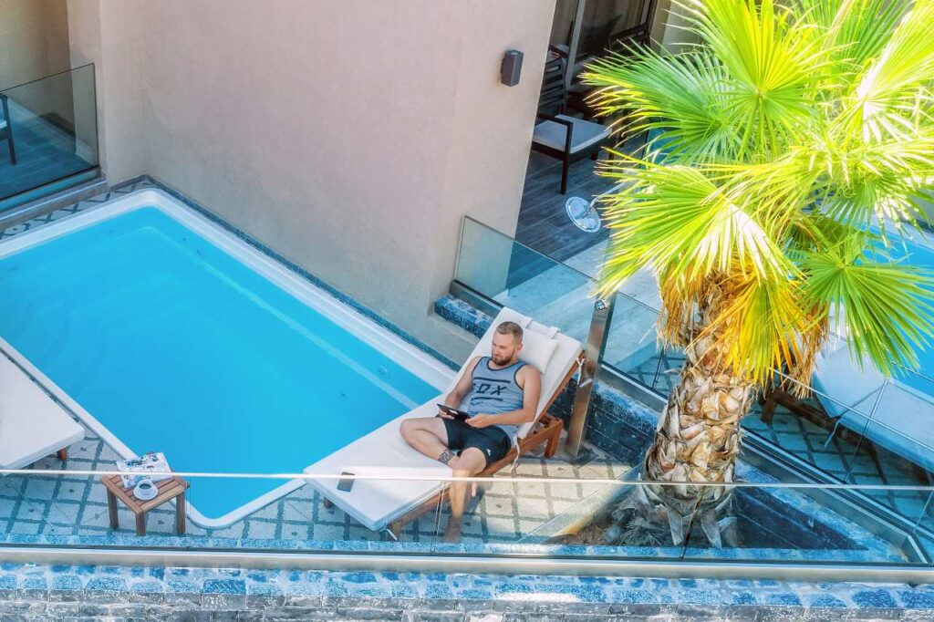 Axel Beach Crete outdoor pool area with palm trees viewed from above