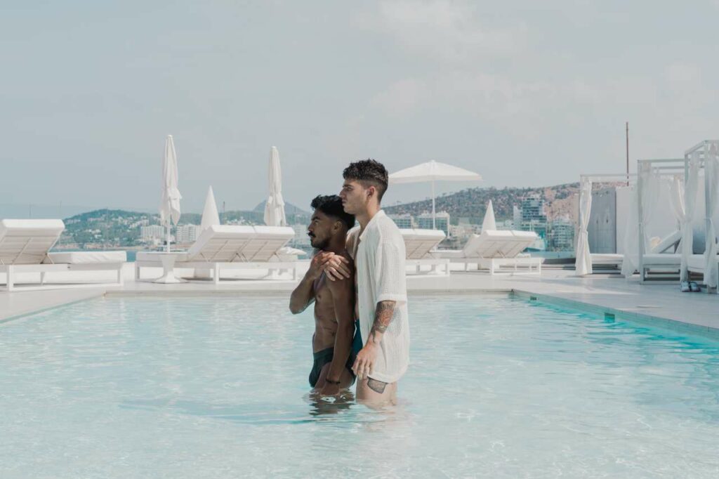 Two men embracing at the Axel Beach Ibiza pool