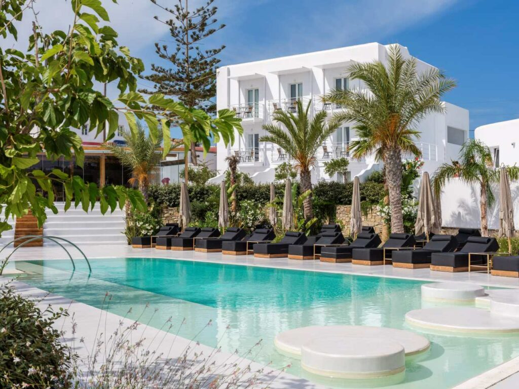 Axel Beach Mykonos hotel exterior with pool and palm trees