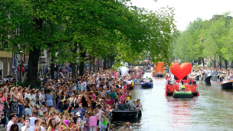 Crowds watching the boats at Amsterdam Pride