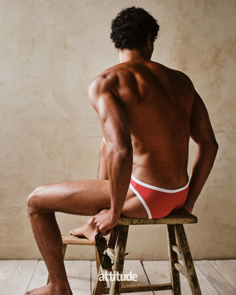 Model wearing red speedos in Attitude magazines swimwear editorial