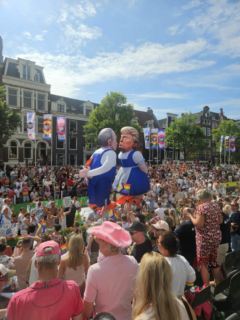 A float at Canal Pride featuring giant inflatable Trump and Putin locking lips