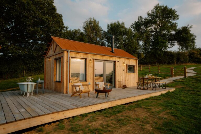 Bright Water cabin set within rolling green countryside at Ridge & Furrow Farm.