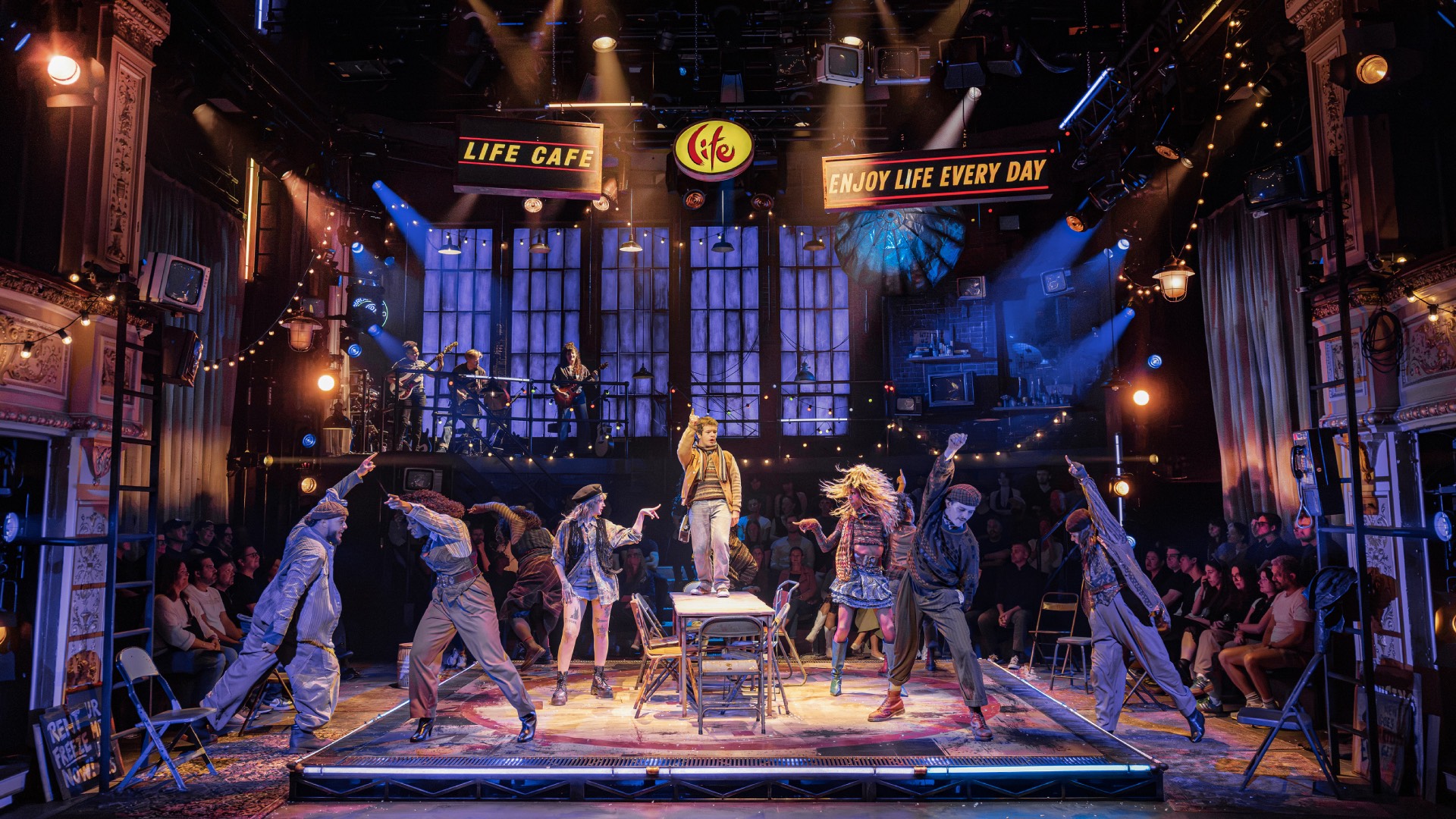 A production shot from the new West End stage show, RENT, showing Gaten Matarazzo (Mark) and Company on stage
